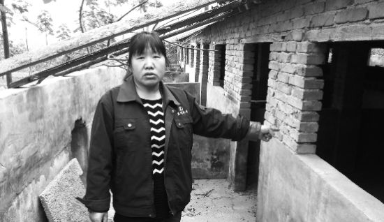 李九玲站在空荡荡的猪舍前一脸无奈